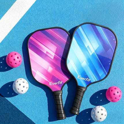 Two pickleball paddles in pink and blue with black grips, with pink and white balls