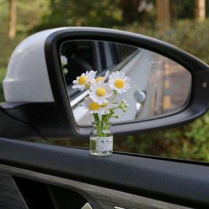 Car side mirror daisy flower decoration in small glass vial with white daisies