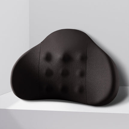 Black contoured lumbar support pillow with tufted dimples and arched shape