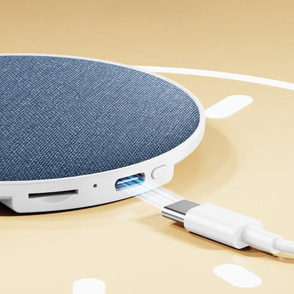 Side view of blue fabric sleep speaker showing USB and charging port