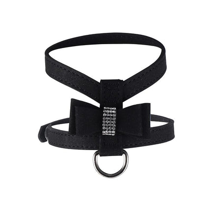 Black dog harness with front bow strap, rhinestone-style buckle, and metal D-ring