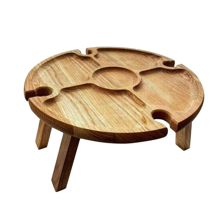 Wooden round folding picnic table with carved compartments and three supporting legs