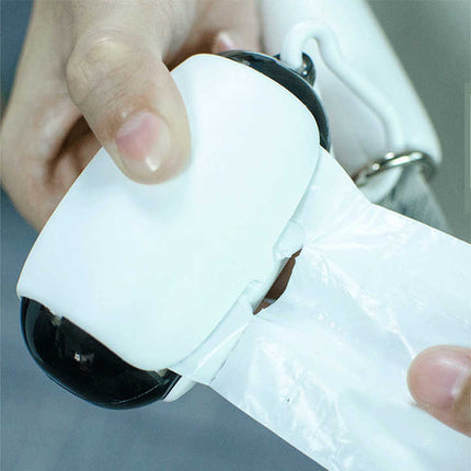 Poop bag dispenser capsule releasing a bag with hand pull