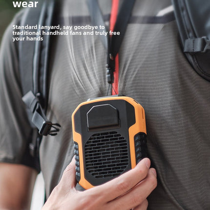 Portable fan held in hand showing front vent grille and top control window