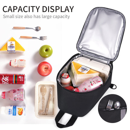 Black insulated lunch bag open with silver lining, holding lunch items and utensils