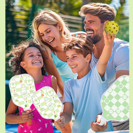 Family playing outdoors with cartoon pickleball paddles; kid holds a yellow ball