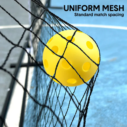 Close-up of pickleball net mesh holding a yellow pickleball